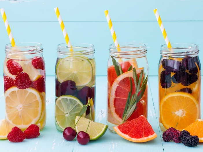 Four glasses of fruit-infused water