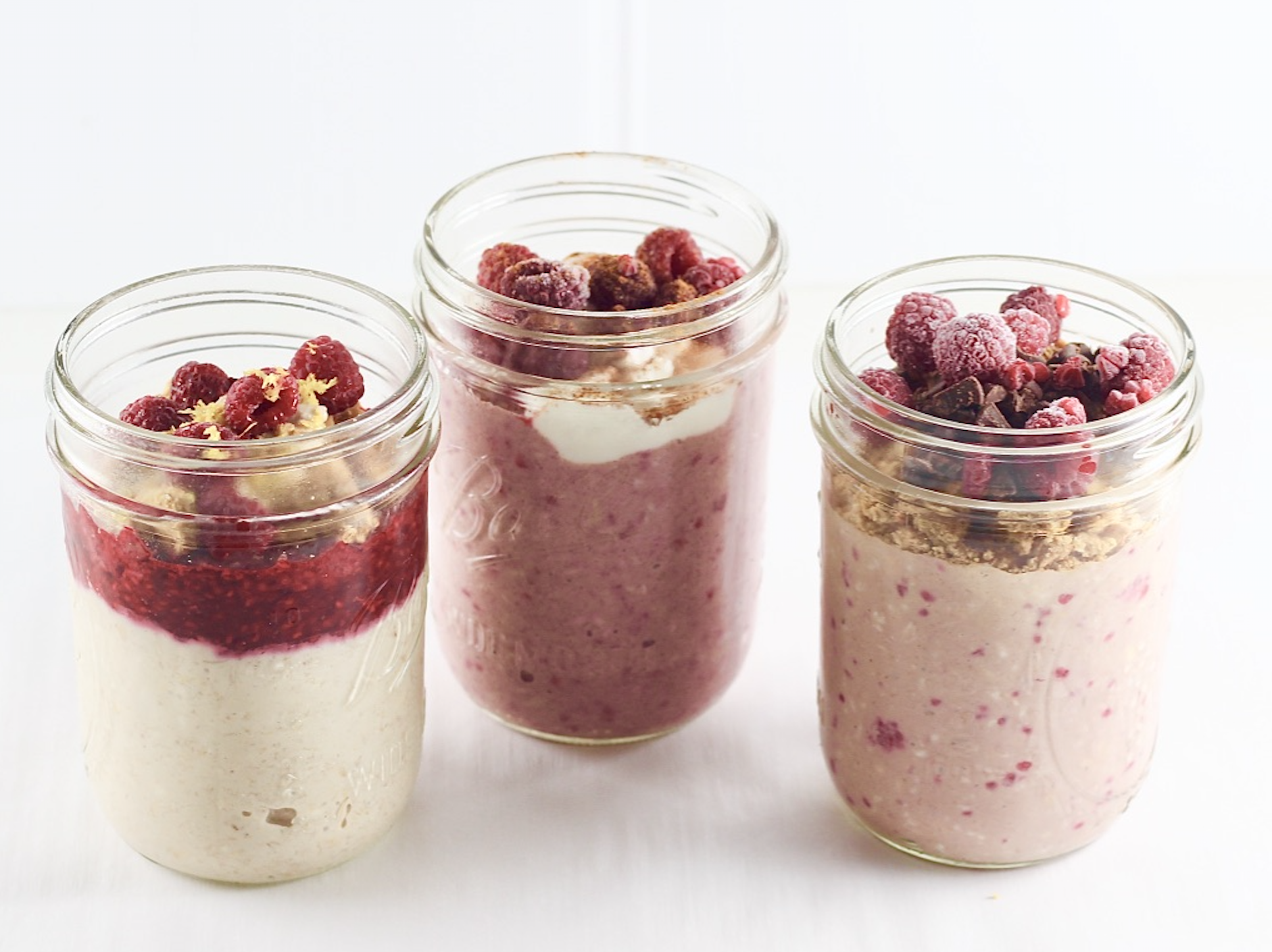 3 variations of overnight oats in mason jars, raspberry lemon cheesecake, spiced raspberry and raspberry s'more