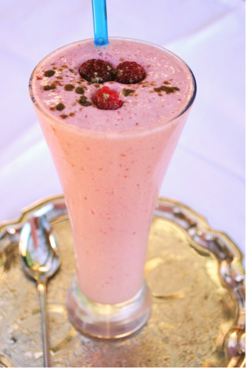 Raspberry Lassi in a tall glass on a silver platter