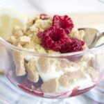 Raspberry Lemon Cheesecake Parfaits in clear glass with a spoon
