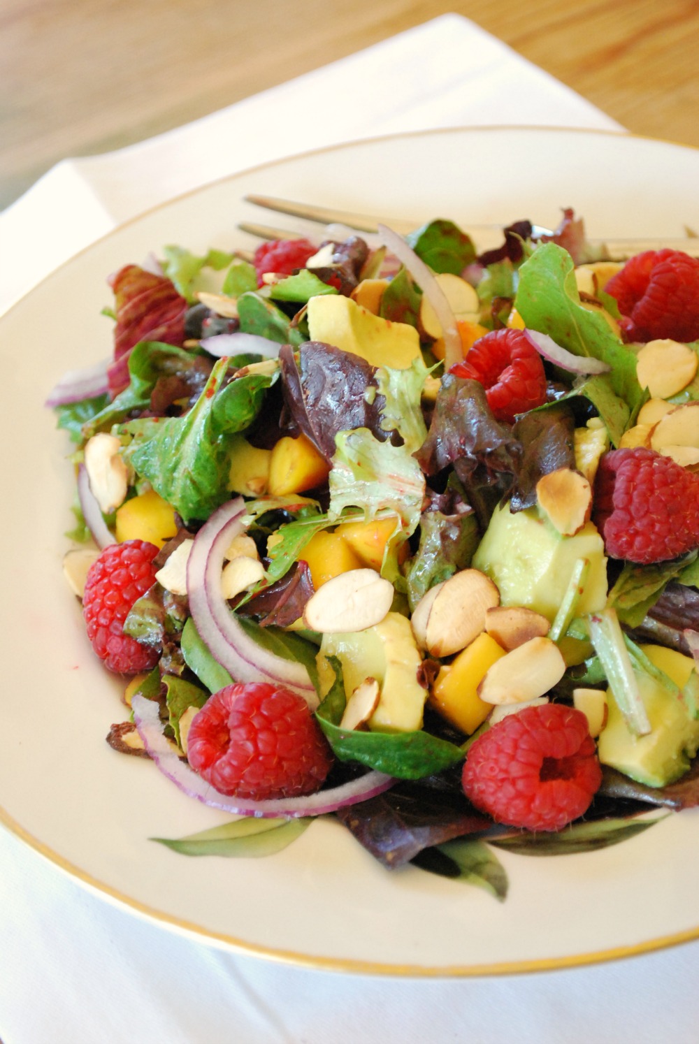 Raspberry, Avocado & Mango Salad, with mixed greens, red onion and almonds