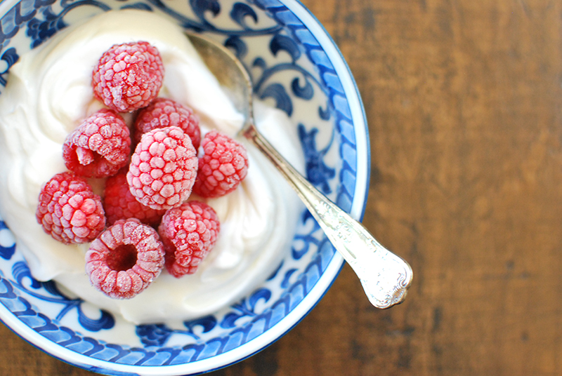 yogurt topped with frozen raspberries
