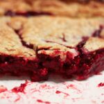 All-Year Raspberry Pie with slices missing to see fruit filling
