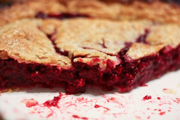 All-Year Raspberry Pie with slices missing to see fruit filling