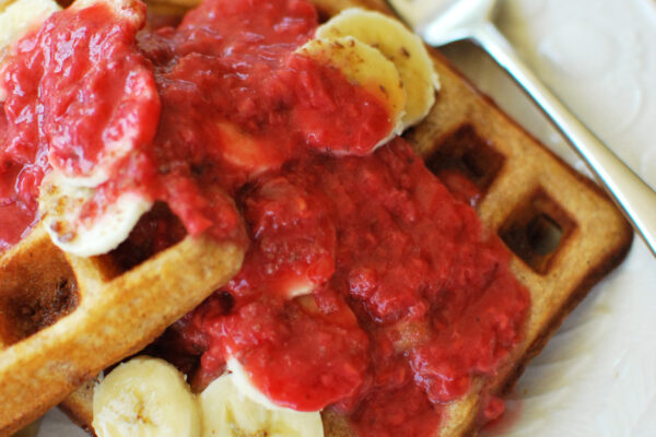 Waffles topped with Raspberry Orange Sauce and bananas