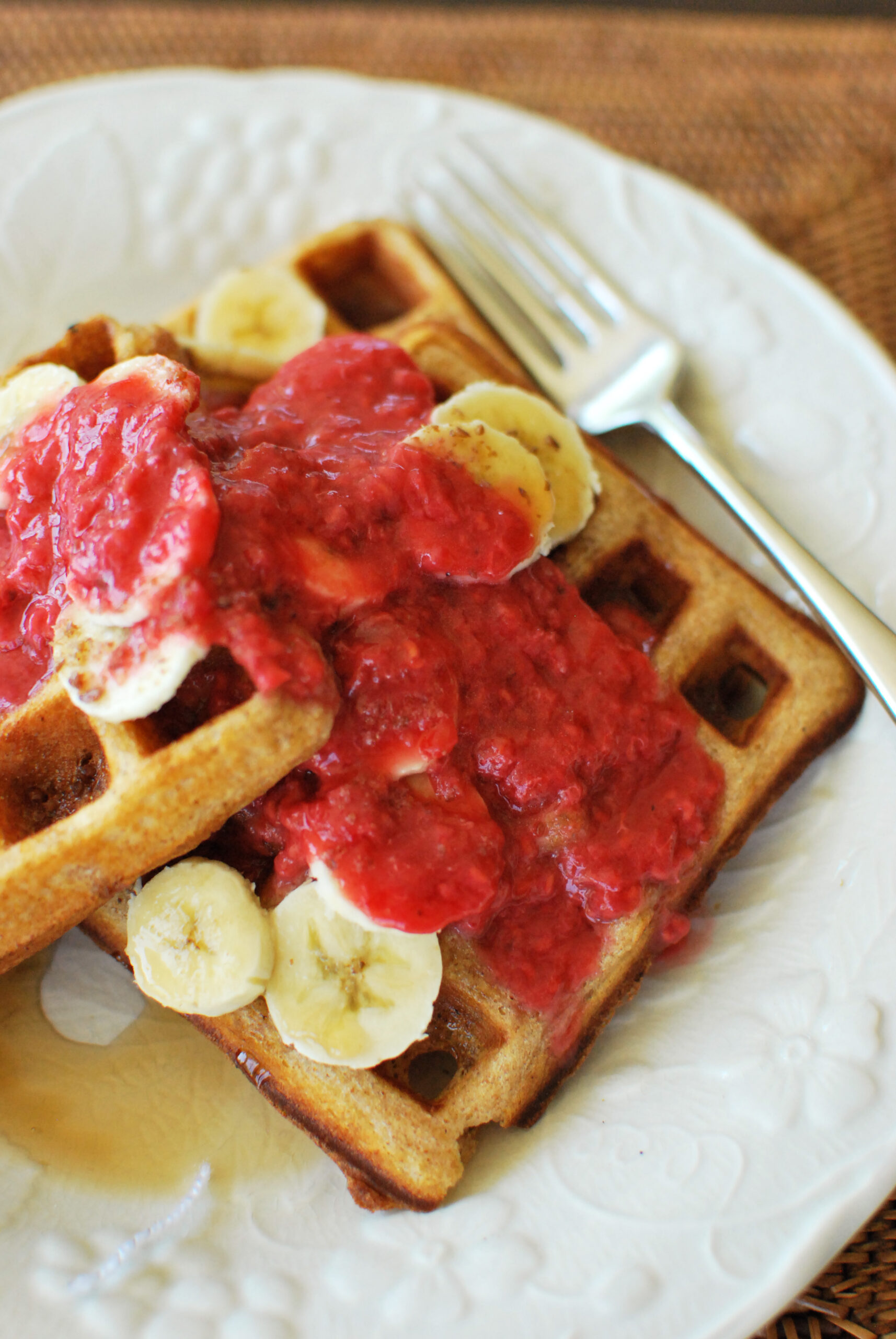 Waffles topped with Raspberry Orange Sauce and bananas